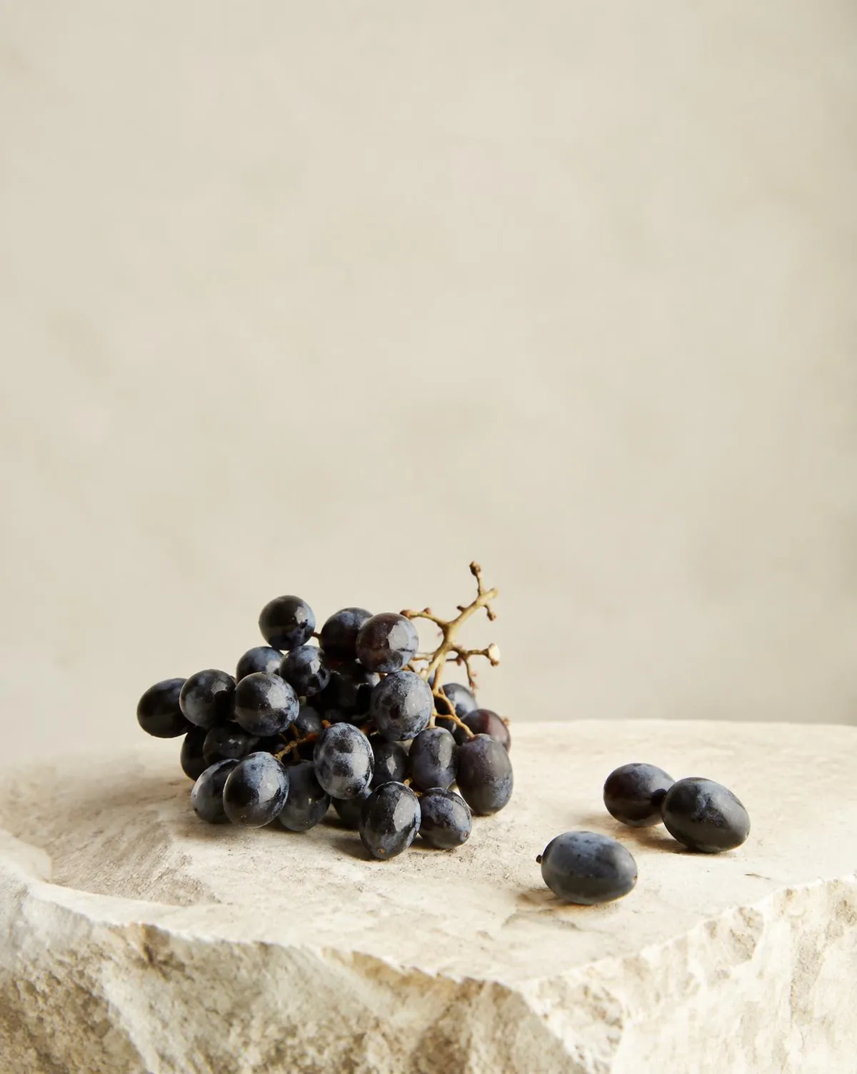 Grappe de raisin noir sur une pierre calcaire